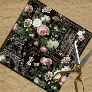 Macro shot of vintage scrapbooking paper with floral roses and Eiffel Tower design