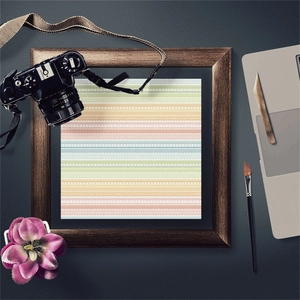 Detail of vintage scrapbooking paper with multi-colored lace patterns in a dark wood frame