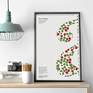 Framed vintage ladybug and strawberry poster in a modern home office setting