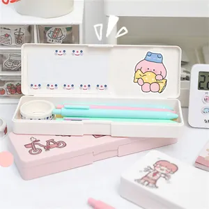 Detail of cute bear stationery box storage with stickers and pens in a cozy desk setup