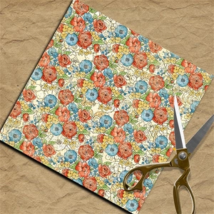 Detail of vintage floral scrapbooking paper with scissors on rustic kraft background
