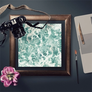 Macro detail of vintage blue ocean wave art paper inside a dark wooden photo frame