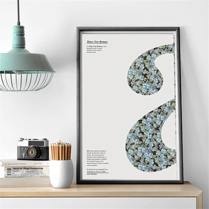 Framed vintage scrapbook paper with blue floral quotation art on a wooden desk