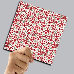 Detailed close-up of vintage ladybug and floral pattern decorative scrapbook paper sheets