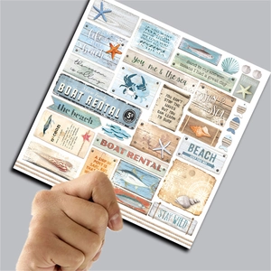 Detail shot of ocean themed scrapbooking paper featuring sea life and vintage nautic signs