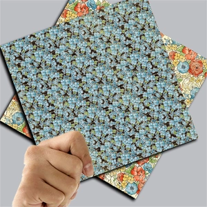 Macro view showing vintage floral pattern collage paper with matte finish for scrapbooking
