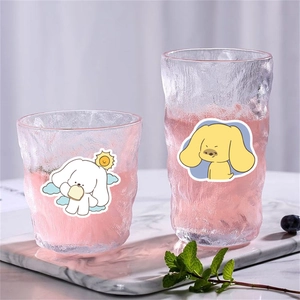 Hammered texture glass cup set with cute cartoon dog stickers on marble base