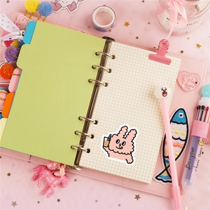 Detail view of pink rabbit stationery set including binder notebook stickers and pen