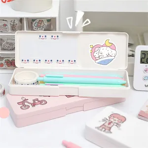 Close-up of white and pink matte plastic stationery boxes with cute cartoon stickers