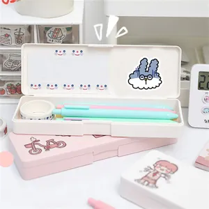 Close-up of pastel stationery organizers with cute bunny stickers and macaron pens
