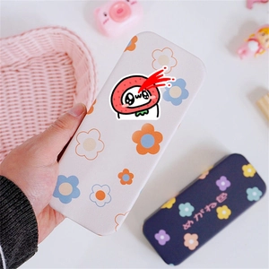 Close-up of cute floral eyeglass cases with leather texture and strawberry patterns