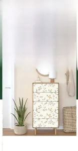 Floral self-adhesive wallpaper applied to a wooden cabinet drawer for furniture renovation