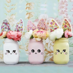 Easter rabbit DIY decorative stickers on three pastel ceramic vases with faux flowers