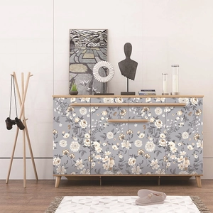 Nordic storage cabinet with four floral pattern doors and light wood legs in living room