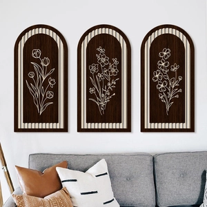 Detailed view of bohemian green arched wood wall art set with white floral engravings