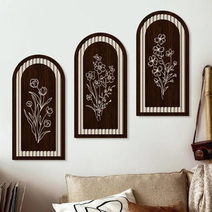 Three-piece arched wooden wall art with white floral line drawings in farmhouse style