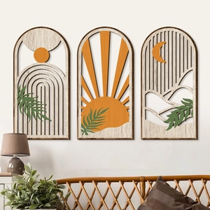 Detailed laser-cut boho wooden wall art featuring mountain and leaf motifs in a cozy room