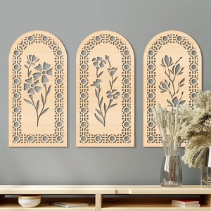Set of 3 arched wooden wall art panels with intricate laser-cut floral patterns