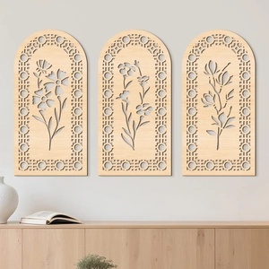 Detailed close-up of three-piece arched floral wooden wall art with laser-cut botanical patterns
