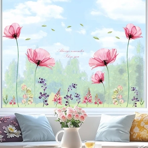 Close-up of floral wall decals featuring watercolor poppies and inspirational text on a window