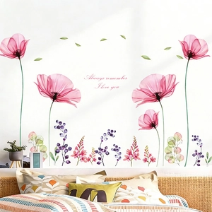 Detail of floral wall stickers with pink flowers and text in a bedroom setting