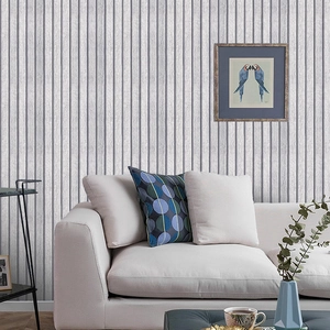 Vertical grey wood grain texture wallpaper shown behind a sofa in a modern living room