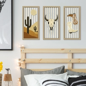 Three-piece American western cactus and skull wooden wall art hanging above a bed