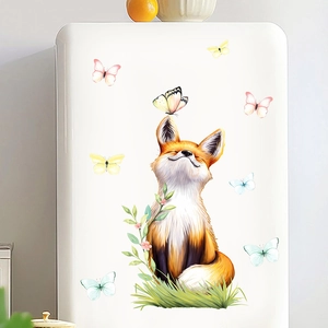 Detail of cute orange fox sticker with butterflies on a white refrigerator surface