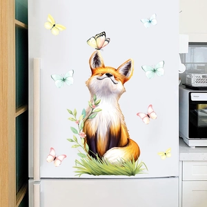 Detailed close-up of cartoon fox and butterfly PVC window stickers on a white surface