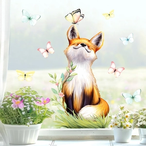 Detail of cartoon fox and butterfly static window stickers on bright glass surface