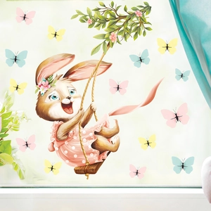 Detail of Easter bunny swinging on branch with colorful butterflies window sticker