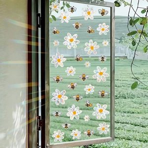 Holographic bee and daisy window stickers creating rainbow prism effects in sunlight