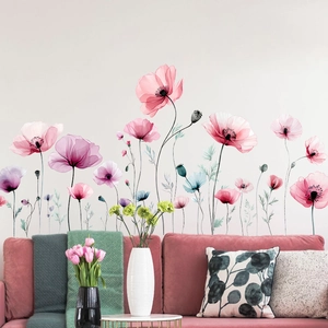 Close-up of watercolor floral wall stickers with pink and purple poppies on a living room wall