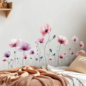Close-up of watercolor floral wall stickers in pastel pink and purple on bedroom wall