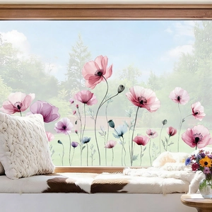 Detail view of semi-transparent watercolor flower stickers on a bright window pane