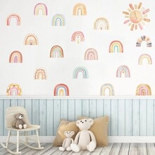Detail of self-adhesive rainbow wall stickers in a cozy Nordic nursery setting
