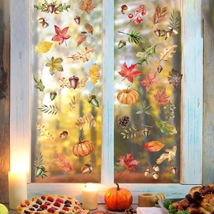 Detail of autumn pumpkin and maple leaf window stickers in a cozy festive setting