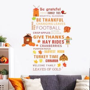 Autumn window clings with pumpkins and maple leaves shown in a living room decor