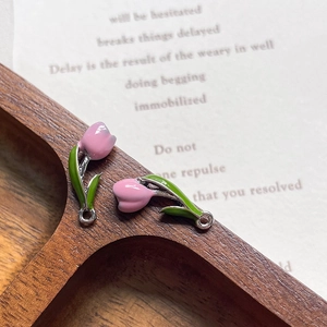 Macro detail of 3D tulip flower alloy charms with pink enamel petals for DIY jewelry making