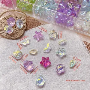 Macro shot of iridescent glass beads in seashell and butterfly shapes for DIY crafts