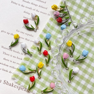 Macro detail of colorful tulip charms for DIY jewelry making with gold-tone enamel finish