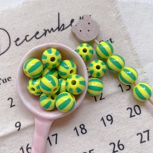 Macro detail of striped colorful beads in heart and star motifs for DIY jewelry crafts