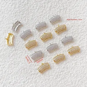 Macro detail of 10mm curved zircon tube bead in gold and silver for jewelry making