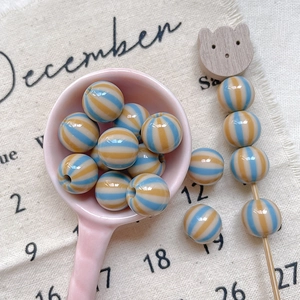 Close-up of colorful striped acrylic round beads for DIY jewelry and phone chains