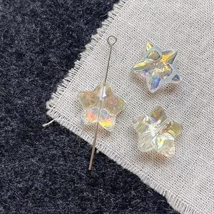 Detailed view of iridescent glass star beads for DIY handmade jewelry and craft projects