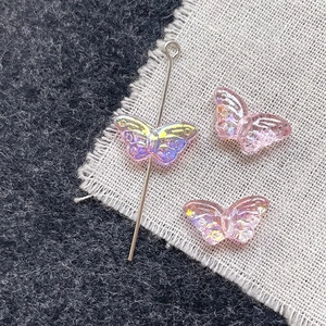 Macro detail of iridescent butterfly resin beads with wing textures for DIY jewelry making