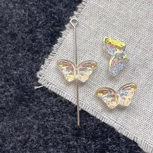 Detail view of butterfly glass beads with iridescent finish for DIY jewelry crafts