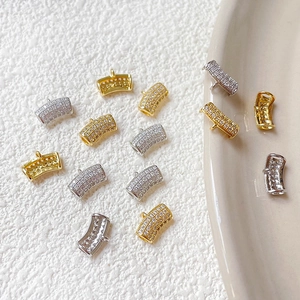 Detailed view of curved micro-pave zircon charms in gold and silver for DIY jewelry