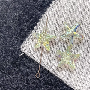 Macro detail of iridescent glass starfish beads with colorful AB coating for DIY jewelry