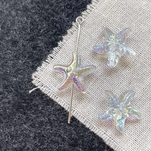 Detailed macro view of colorful AB coated starfish glass beads with metal pin for DIY jewelry